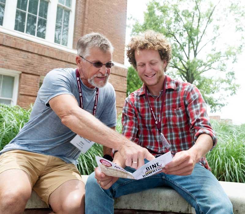 parent and child looking at campus brochure